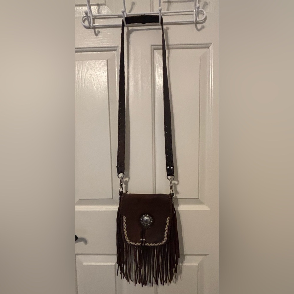 Handcrafted leather fringe bag with hand beaded edge and silver concho